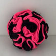 Fluorescent pink and black anti-pill fleece snuffle ball for dogs, handmade in the UK, ideal for mental stimulation and foraging