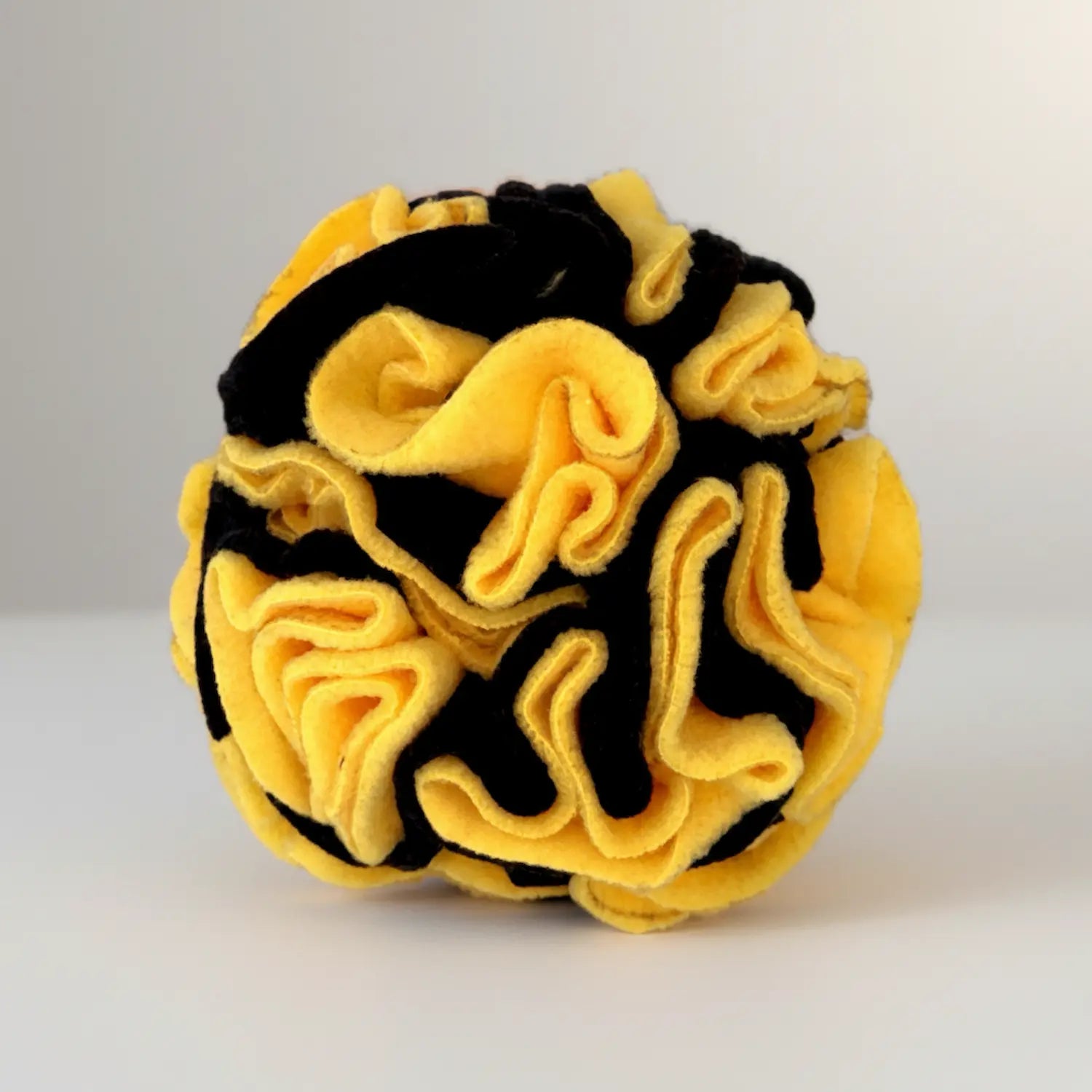 Yellow and black anti-pill fleece snuffle ball for dogs, handmade in the UK, ideal for mental stimulation and foraging